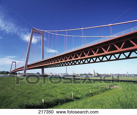Stock Image - Low angle view of suspension bridge . Fotosearch