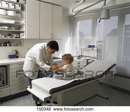 Stock Photo - Male doctor giving a shot to a girl . Fotosearch