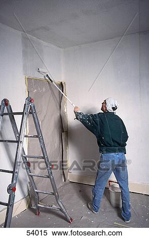 Man painting wall View Large Photo Image Stock Photography - Man painting wall . Fotosearch