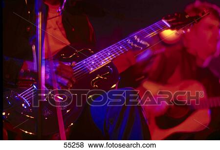 Mid section view of man playing guitar on stage View Large Photo Image Stock Photo - Mid section view of man playing guitar on stage . Fotosearch