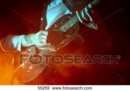 Mid section view of man playing guitar on stage View Large Photo Image Stock Photo - Mid section view of man playing guitar on stage . Fotosearch