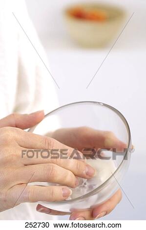 Mid section view of woman holding bowl of moisturizer View Large Photo Image Stock Image - Mid section view of woman holding bowl of moisturizer . Fotosearch