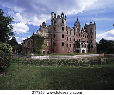 Stock Photograph - Moat surrounding castle under cloudy sky . Fotosearch