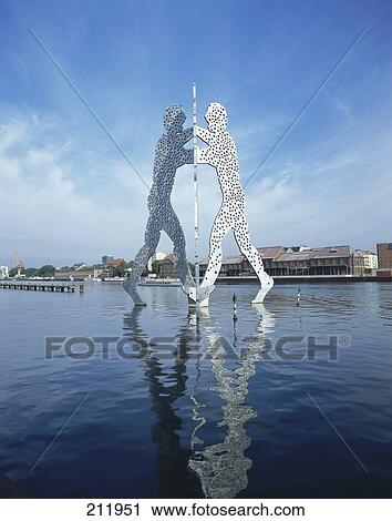 Stock Image - Molecule men sculpture in river, Spree River, Treptow, Berlin, Germany . Fotosearch