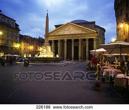 Obelisk lit up near restaurant in city square, Pantheon Rome, Frieze, Italy View Large Photo Image Stock Photo - Obelisk lit up near restaurant in city square, Pantheon Rome, Frieze, Italy . Fotosearch