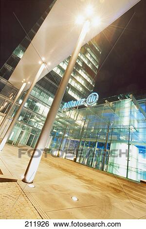 Stock Photograph - Office building lit up at dusk, Allianz Building, Frankfurt, Hesse, Germany . Fotosearch