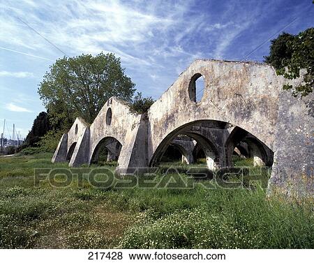 Stock Photo - Old weathered archways in field . Fotosearch