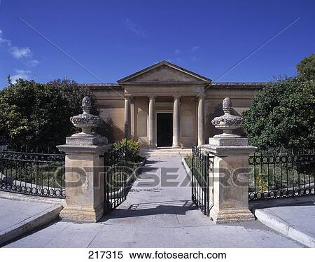 Stock Photography - Open gate leading to facade of building . Fotosearch