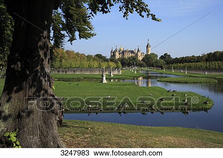 Stock Image - Palace garden and Schwerin Castle in the background, Schwerin, Germany . Fotosearch