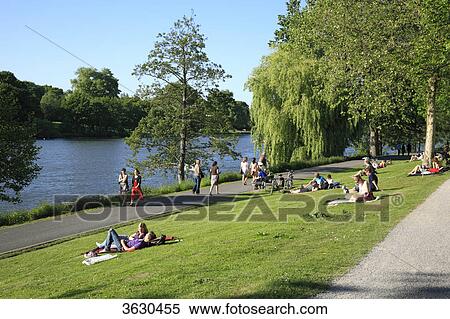 Stock Photography - People at the lakeshore of the Aasee, Muenster, Germany . Fotosearch