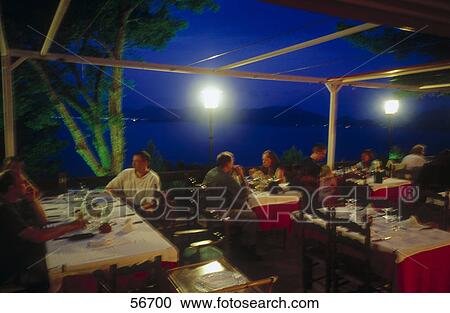 Stock Image - People sitting on terrace of restaurant, Mirador de la Victoria, Alcudia, Mallorca, Balearic Islands, Spain . Fotosearch