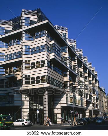 Stock Image - People walking on roadside in front of building, Germany, Europe . Fotosearch