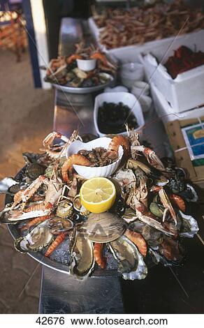 Platter of shrimp and oysters with other seafood in a restaurant, Biarritz, France, Europe View Large Photo Image Stock Photograph - Platter of shrimp and oysters with other seafood in a restaurant, Biarritz, France, Europe . Fotosearch
