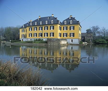 Stock Image - Reflection of building in river, Huckelhoven, Heinsberg, North Rhine-Westphalia, Germany . Fotosearch