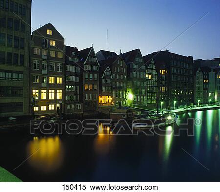 Stock Photography - Reflection of buildings in river at dusk, Nikolaifleet, Hamburg, Germany . Fotosearch