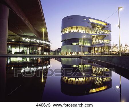 Stock Image - Reflection of buildings lit up at dusk, Baden-Wurttemberg, Germany . Fotosearch