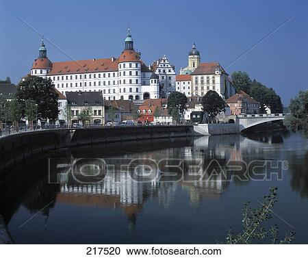 Stock Image - Reflection of castle in water with St. Maria church in background, Residenzschloss, Danube River, Neuburg, Bavaria, Germany . Fotosearch