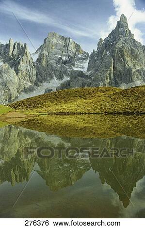 Stock Photograph - Reflection of mountain in water, Pala di San Martino, Dolomites, Trentino-Alto Adige, Italy . Fotosearch