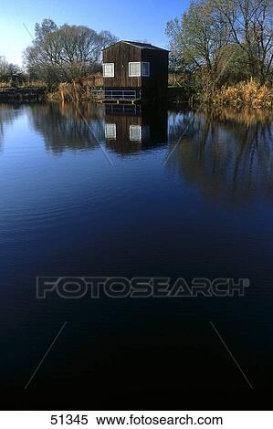 Stock Photography - Reflection of wooden hut in water, Usedom Island, Germany . Fotosearch