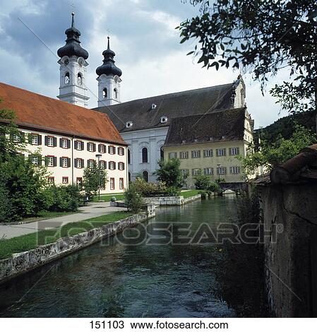 Stock Image - River flowing beside church, Swabian, Baden Wurttemberg, Germany . Fotosearch