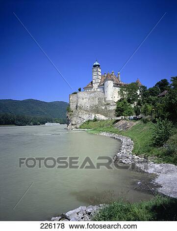 Stock Photo - River flowing in front of palace, Danube River, Schoenbuehel Palace, Austria . Fotosearch