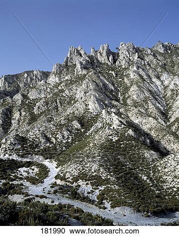 Stock Image - Road running through mountainous region, Granada, Andalusia, Spain . Fotosearch