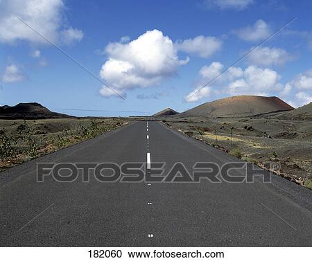 Road running through volcanic landscape, Lanzarote, Canary Islands, Spain View Large Photo Image Stock Image - Road running through volcanic landscape, Lanzarote, Canary Islands, Spain . Fotosearch