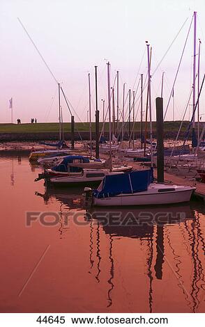 Stock Photography - Sailboats at harbor, Bensersiel, Germany . Fotosearch