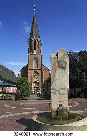 Saint Catherine of Siena church in Lindern (Oldenburg), water fountain in the foreground, Germany View Large Photo Image Stock Image - Saint Catherine of Siena church in Lindern (Oldenburg), water fountain in the foreground, Germany . Fotosearch