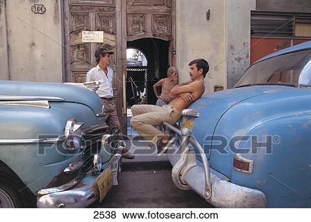 Side profile of man relaxing between old cars, Old Havana, Havana, Cuba View Large Photo Image Stock Photo - Side profile of man relaxing between old cars, Old Havana, Havana, Cuba . Fotosearch
