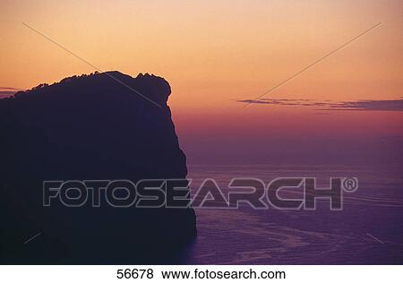 Silhouette of a cliff on a coast View Large Photo Image Stock Photo - Silhouette of a cliff on a coast . Fotosearch
