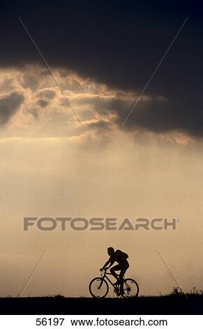 Stock Photo - Silhouette of man cycling . Fotosearch