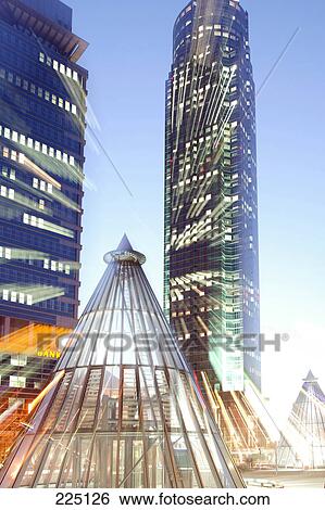 Stock Photograph - Skyscrapers lit up in city, Messeturm Tower, Frankfurt, Hesse, Germany . Fotosearch