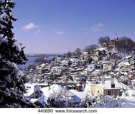 Stock Image - Snow-covered houses in town . Fotosearch