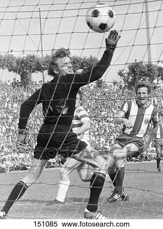 Stock Photography - Soccer ball going past goalkeeper during soccer match . Fotosearch
