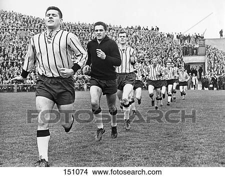 Picture - Soccer players running in stadium, Boekelberg Stadium, Hanover, Germany . Fotosearch