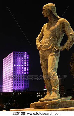 Stock Photo - Statue of man litup at night, Mainforum, Frankfurt, Hesse, Germany . Fotosearch