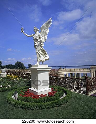 Stock Image - Statue on pedestal in garden, Schwerin, Germany . Fotosearch