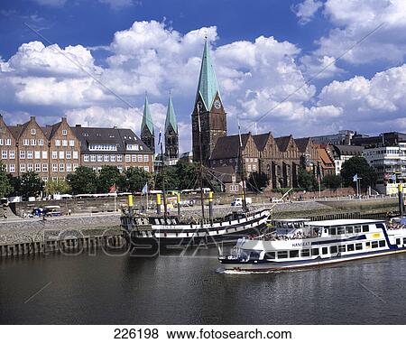 Stock Photo - Tour boat sailing through city in river, Bremen, Germany . Fotosearch