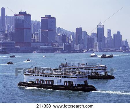 Tourboats in river with buildings in background, China View Large Photo Image Stock Photo - Tourboats in river with buildings in background, China . Fotosearch