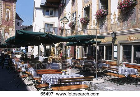 Tourists at cafe, Mittenwald, Garmisch-Partenkirchen, Bavaria, Germany View Large Photo Image Stock Photo - Tourists at cafe, Mittenwald, Garmisch-Partenkirchen, Bavaria, Germany . Fotosearch