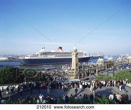 Stock Image - Tourists at coast with cruise ship in background, Hamburg, Germany . Fotosearch