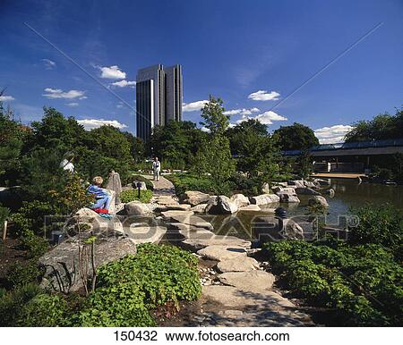 Stock Image - Tourists at garden in town, Hamburg, Germany . Fotosearch