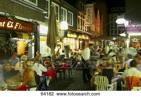 Stock Image - Tourists at outdoor cafe, Schneider-Wibbel-Gasse, Duesseldorf, North Rhine-Westphalia, Germany . Fotosearch