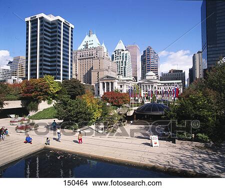 Picture - Tourists at park in city in front of buildings, Robson Square, Vancouver, British Columbia, Canada . Fotosearch