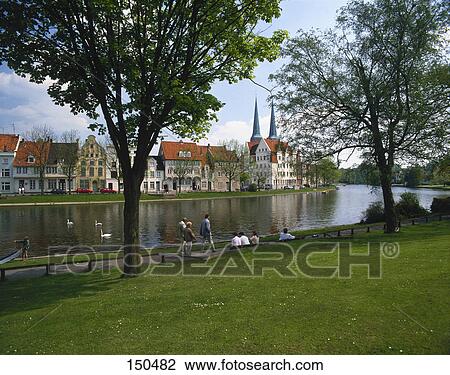 Tourists at riverside, Trave River, Luebeck, Schleswig-Holstein, Germany View Large Photo Image Stock Image - Tourists at riverside, Trave River, Luebeck, Schleswig-Holstein, Germany . Fotosearch