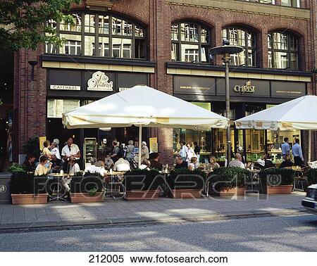 Stock Photography - Tourists at sidewalk cafe in city, Moenckebergstrasse, Hamburg, Germany . Fotosearch