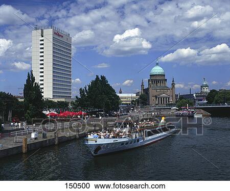 Stock Image - Tourists in boat at harbor . Fotosearch