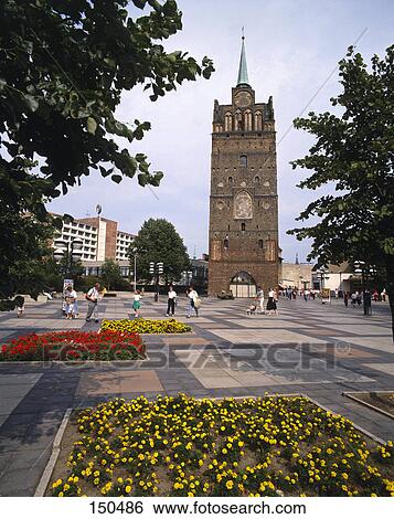 Stock Photograph - Tourists in front of old tower, Rostock, Germany . Fotosearch