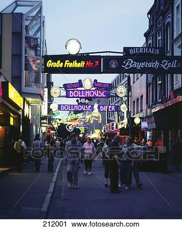 Stock Image - Tourists in street at dusk, Reeperbahn, Sankt Pauli, Hamburg, Germany . Fotosearch